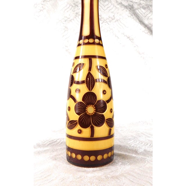 This is a tan over red cut to clear glass decanter with a stopper that is only red but matches the design and it fits...