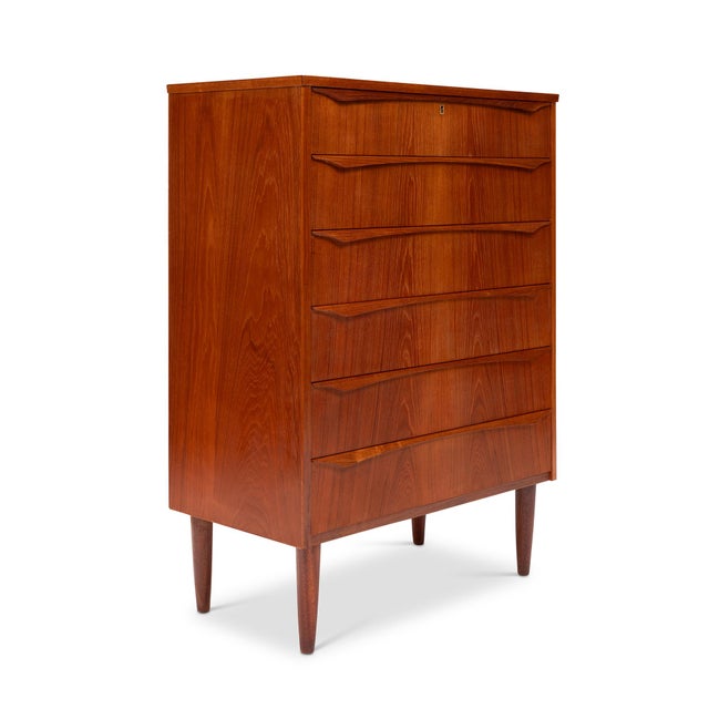 This stunning 1960s Danish Mid-Century teak tallboy dresser is a timeless piece of craftsmanship. Featuring exquisite wood...