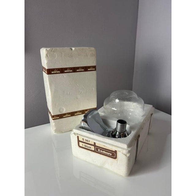 This wall lamp by Novus is a typical piece from the Space Age era. The lamp captivates with its striking combination of...