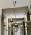 French moderne brass patinated six-arm chandelier, attributed tp Maison Lunel, France. Sleek detailing including curved...