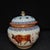 A beautiful pair of Chinese Famille Rose porcelain covered jars. The white ground is hand-painted with detailed oxen in a...