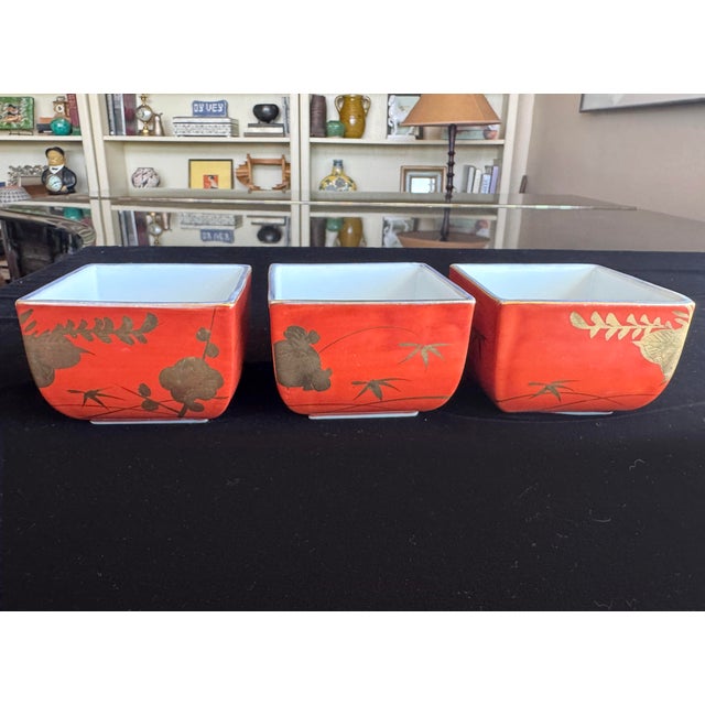 This refined set of three antique Japanese square porcelain dishes is decorated in the classic Kinran-de style, a gold-...