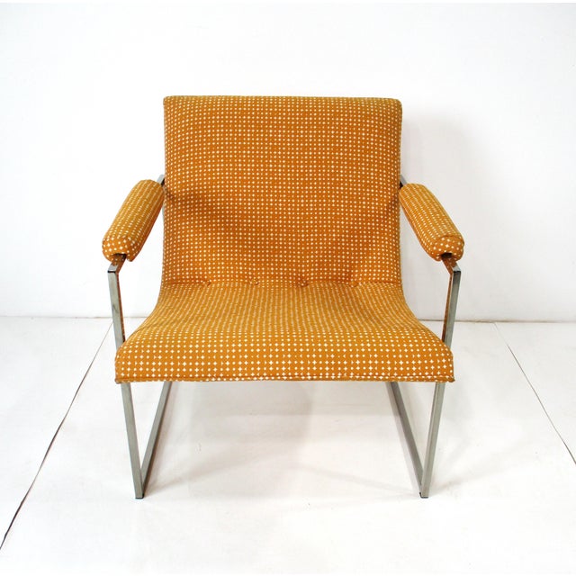 A elegant and comfortable Scoop lounge chair with square chrome tubed steel base having rolled arm rests and includes a...