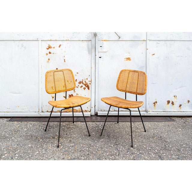 Pair of dining chairs with painted iron rod frame and wicker seat and back. Model 550 Designer Dirk Van Sliedregt 1950s I...