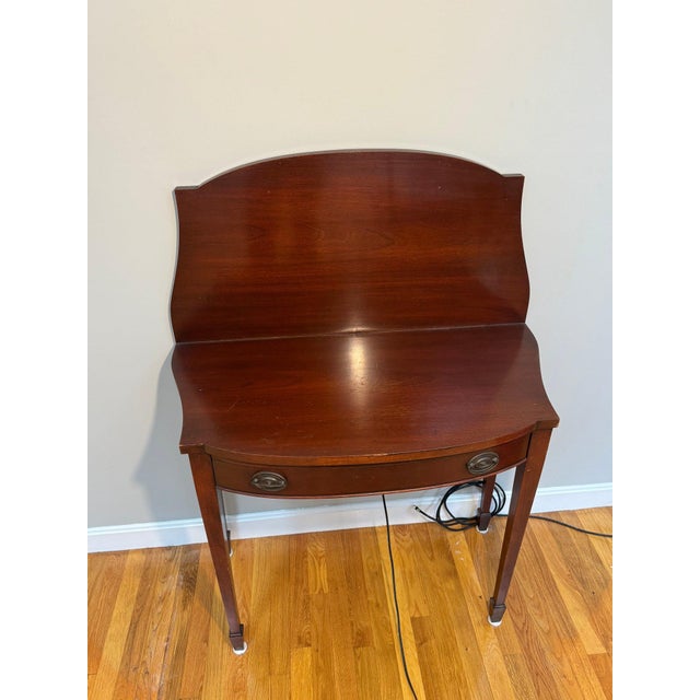 A beautifully crafted mahogany flip-top demi-lune console table that effortlessly transforms from a slim hall table into a...