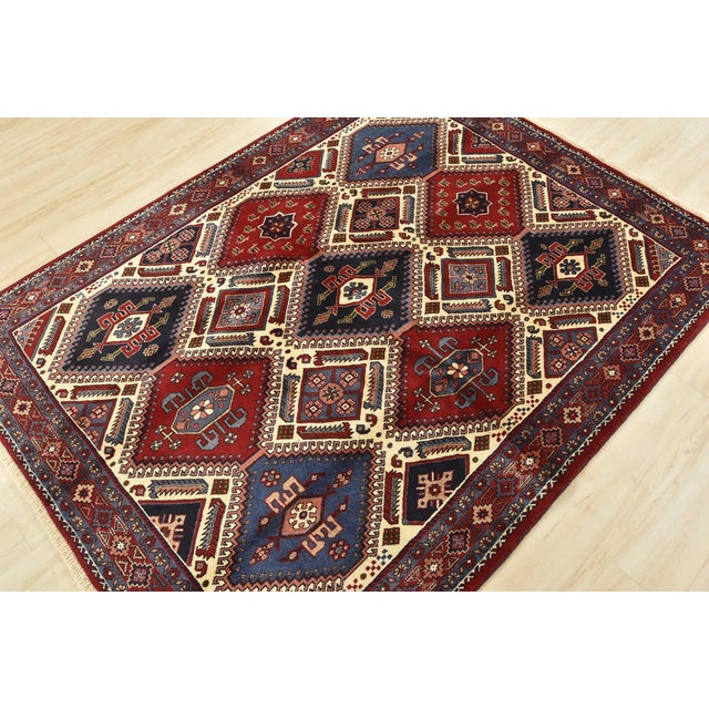 An authentic vintage tribal Yalameh rug hand-knotted with fine wool and natural dyes. This finely woven nomadic rug...