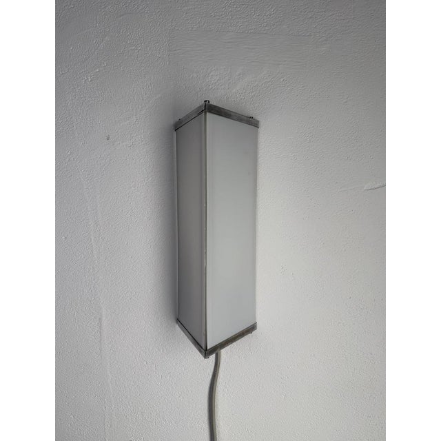 Original vintage wall lamp featuring a distinctive minimalist and geometric design, sourced in Denmark. The lamp has a...