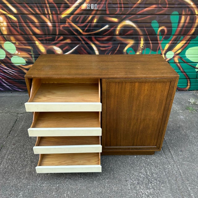 This mid century sliding door sideboard or credenza features 8 drawers, 4 on each side of the piece providing ample...