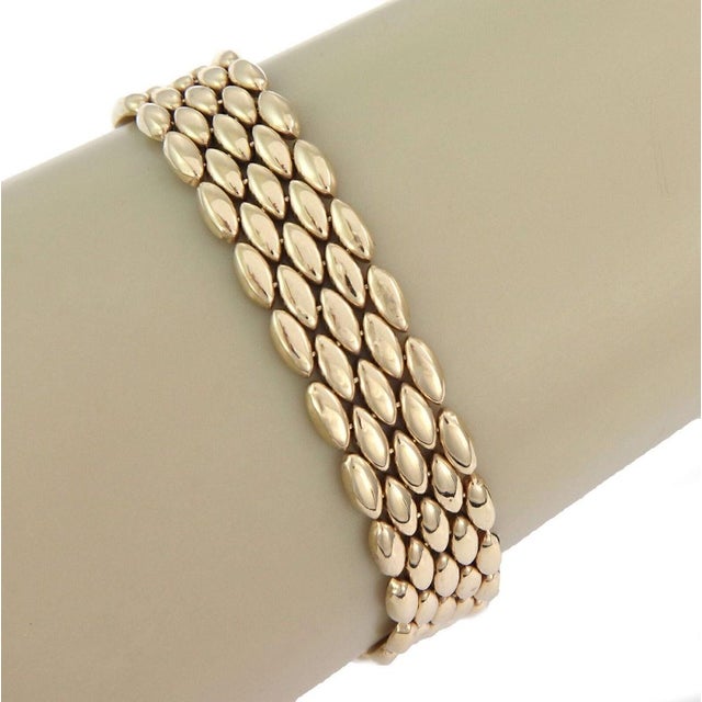 The Five Row 14k Yellow Gold Link Flex Bracelet is a stylish and elegant piece of jewelry that features a chain style...