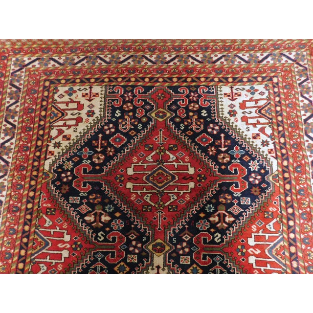 Vintage Persian rug with intricate nomadic motifs. Three geometric medallions on blue field. Rich in tone and very ornate....