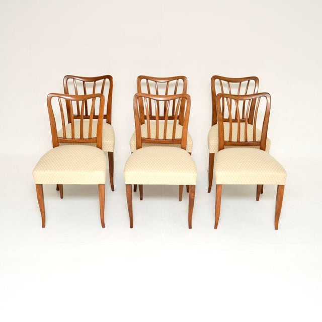 A beautiful and elegant set of six vintage Italian midcentury walnut dining chairs. They date from around the 1950’s. The...