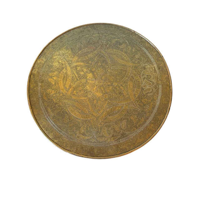 Great Moroccan engraved brass tray with shaped apron on a carved wooden base. Beautiful engraving.