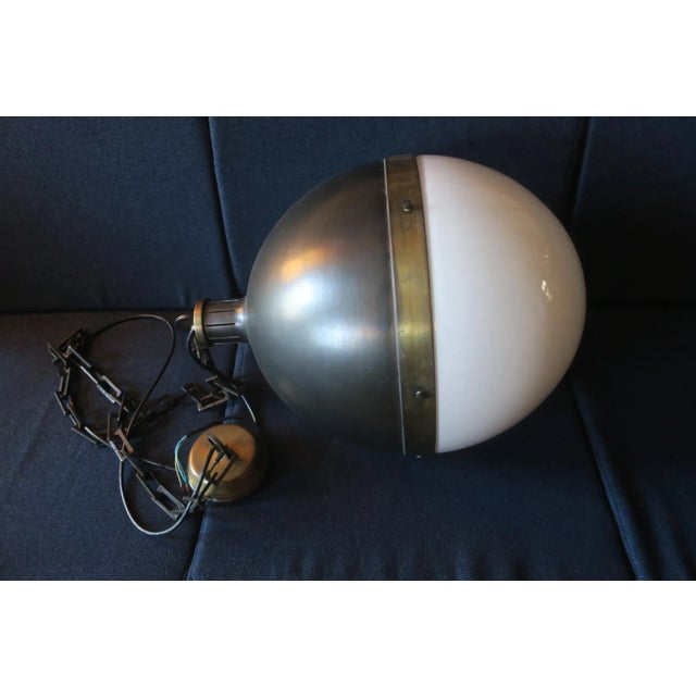 Large Hicks ball pendant light designed by Thomas O'Brien, New York, bronze with hand-rubbed antique brass and milk glass...