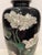 Mid 20th century Meiji style cloisonné vase with a black lacquer background and floral decoration. Metal base and mouth.