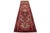 This hand-knotted Persian Heriz wool rug features a red field adorned with a multicolor geometric design. This rug...