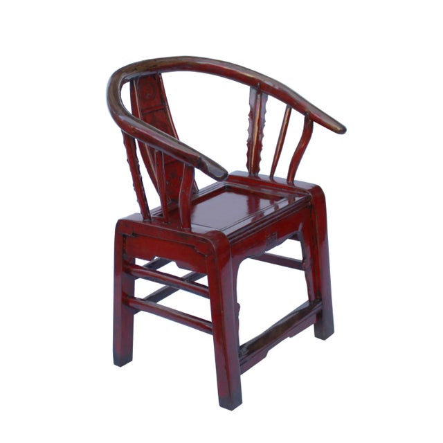 This is an oriental horseshoe shape style armchair with a distressed oxblood red lacquer surface. The seatback is in a...