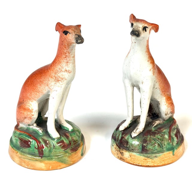 Pair of Victorian Staffordshire Pottery Seated Whippet Figures, Circa 1860 His charming pair of Victorian Staffordshire...