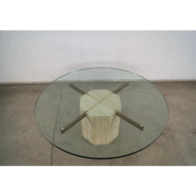 Vintage 1970's Mid century Modern Italian coffee table for sale. It's made of Italian travertine with brass brackets, and...