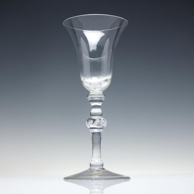 Technical A stunning 18th century Light Baluster wine glass dating to 1750. It has a large bell bowl above an inverted...