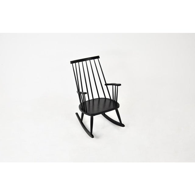Black wooden rocking chair. Seat height: 40 cm. Wear due to time and age. This piece is attributed to the mentioned...
