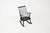 Black wooden rocking chair. Seat height: 40 cm. Wear due to time and age. This piece is attributed to the mentioned...