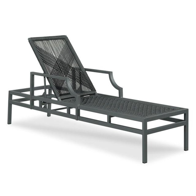 A modern adjustble chaise lounge featuring a graphite gray tubular metal frame supporting a removable cushion in woven...