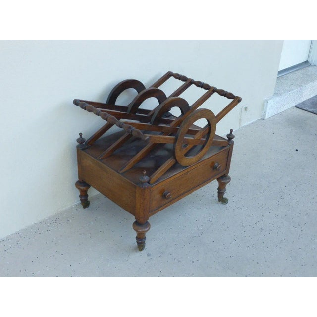 This is an antique Regency style magazine stand exhibiting great flair. The piece dates back to the 19th century and was...