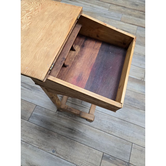 A beautifully constructed early 20th-century American country primitive child's school desk. Crafted from solid wood with...