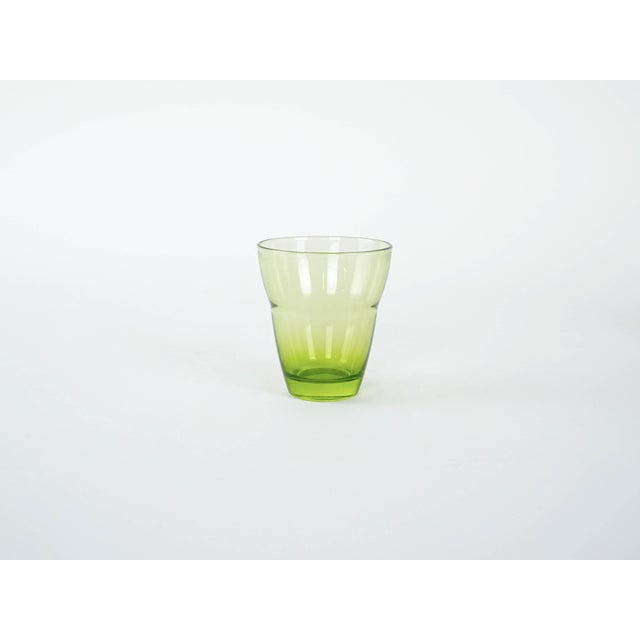 The set of glasses was made in the 1980s in Italy. The transparent glass in a juicy apple shade catches the eye and adds...