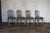A beautiful set of four Italian dining chairs dating to the 1930s, showcasing elegant Neoclassical styling and exceptional...