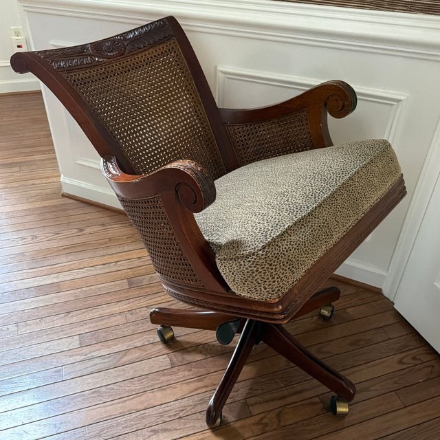 The Loden Desk Chair from Gaines McHale Antiques & Home, Baltimore — a carved mahogany swivel desk chair with cane back...