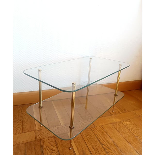Mid-century coffee table in the style of Jansen creations. Made circa 1950-1970. This table features two thick glass tops...