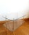 Mid-century coffee table in the style of Jansen creations. Made circa 1950-1970. This table features two thick glass tops...