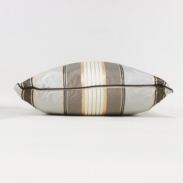 Enhance your decor with this versatile throw pillow in neutral beige and gray tones, adorned with classic stripes for a...