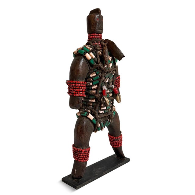 Rich in character and intricate detail, this vintage African carved wooden doll features an expressive sculpted face,...