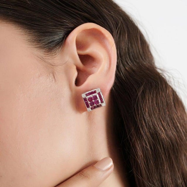 These elegant 4.18 carat natural ruby and diamond stud earrings are crafted in 925 sterling silver and feature a geometric...