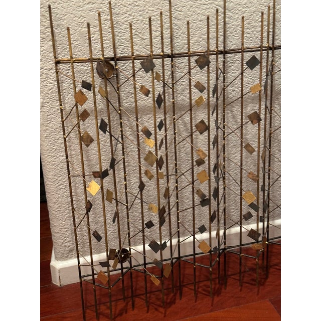 Offered as a pair, these striking Mid-Century Modern metal wall sculptures feature an intricate arrangement of vertical...