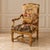 A striking statement chair with a richly decorative damask-style tapestry upholstery featuring a romantic pastoral scene...