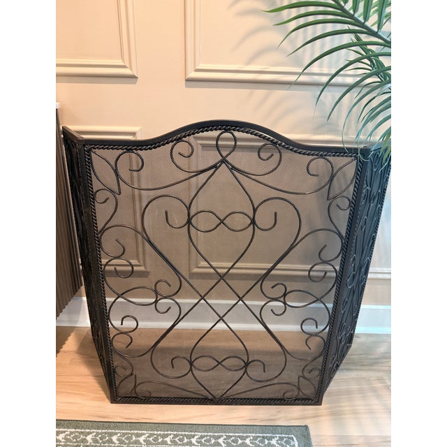 Add timeless elegance to your hearth with this substantial three-panel wrought iron fireplace screen featuring graceful...