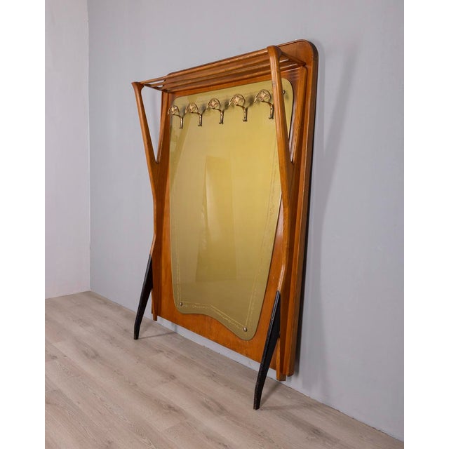 Wall coat rack with wooden frame, decorated green glass and gold-plated brass hooks, Italian design, 1950s.