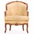 The wood frames are carved with the top rails decorated with floral crests with painted gilt details, all over fluffy...