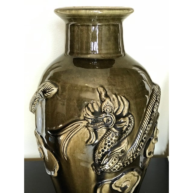 These exquisite oversized Asian ceramic jars/vases stand 18” tall. Each is handmade and unique with a bas relief dragon...