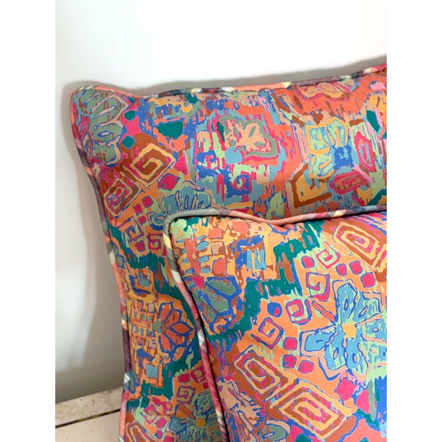 Brightly colored and patterned pair of vintage throw pillows. Fabric is slick and silky to the touch. Please see condition...
