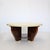 Modernist beautiful hardwood two-tier circular cocktail table with a parchment covered top. The base consists of four...