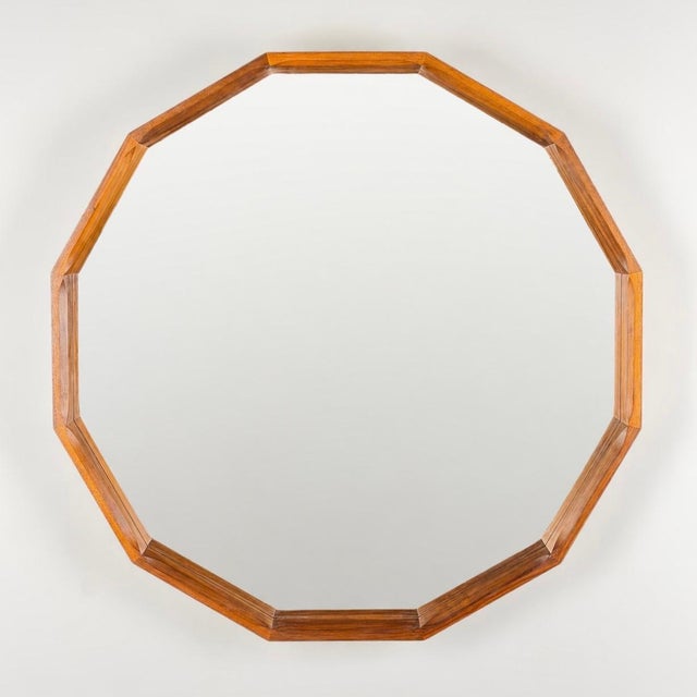 A striking and architecturally refined large dodecagonal mirror crafted in rich Canaletto walnut, Italy, 1970s, attributed...
