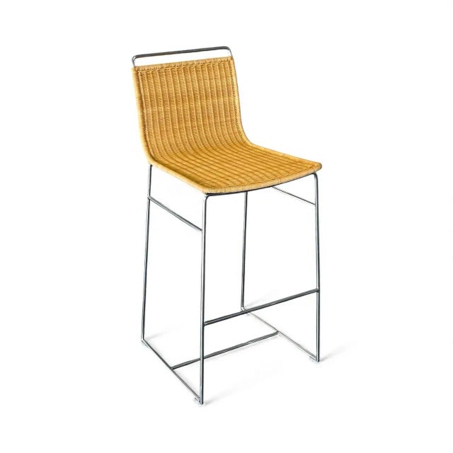 A set of (3) contemporary barstools featuring handwoven natural rattan seats on sleek chrome-plated metal frames. The...