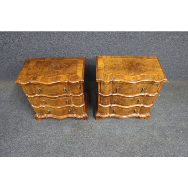 Elegant pair of burl walnut nightstands by Trouvailles Inc., a respected maker and importer of high-quality reproduction...