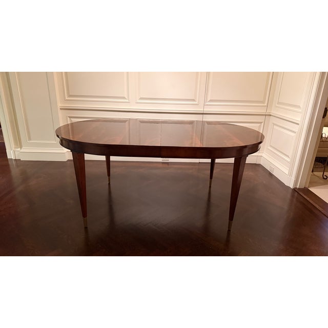 This is an oval dining table with a swirly crotch mahogany top made in the Leighton Hall shop in Suwanee, GA. It features...