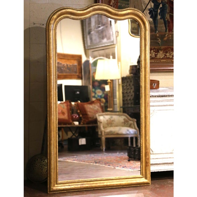 Striking in scale and refined in design, this antique Louis Philippe wall mirror was crafted in France circa 1870. The...
