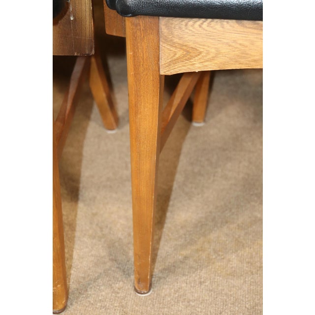 Set of six mid-century dining chairs. Walnut wood frames with black vinyl seats.